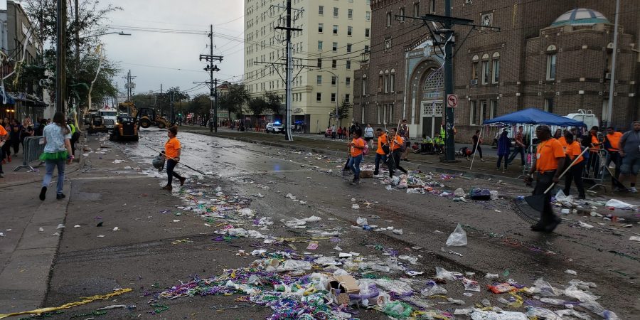 Cleaning crew in orange shirts cleaning the road