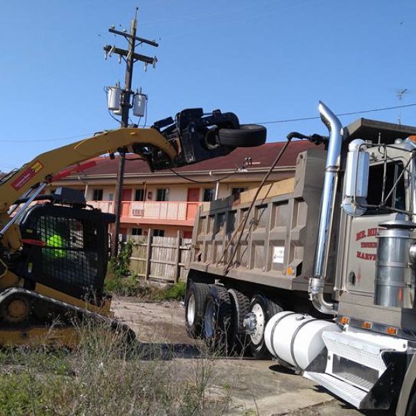 Tire being placed in a dump truck